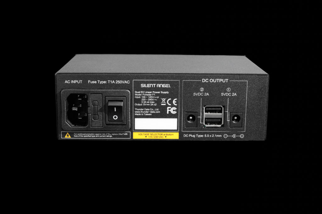 Rear view of Silent Angel Forester F1, highlighting dual 5 V DC outputs (plug and USB) and IEC power input